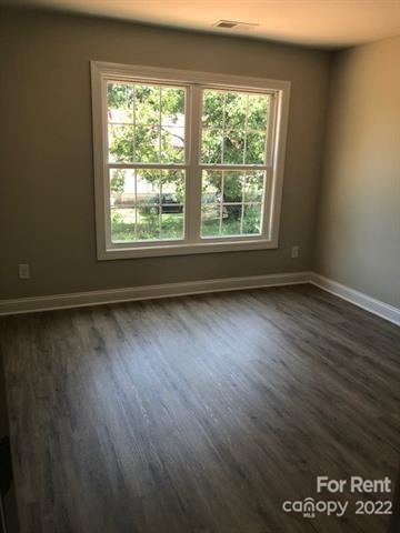 1307 Filbert Street Salisbury, NC 28144 - Photo 9 of 10 an empty room with wooden floor and windows