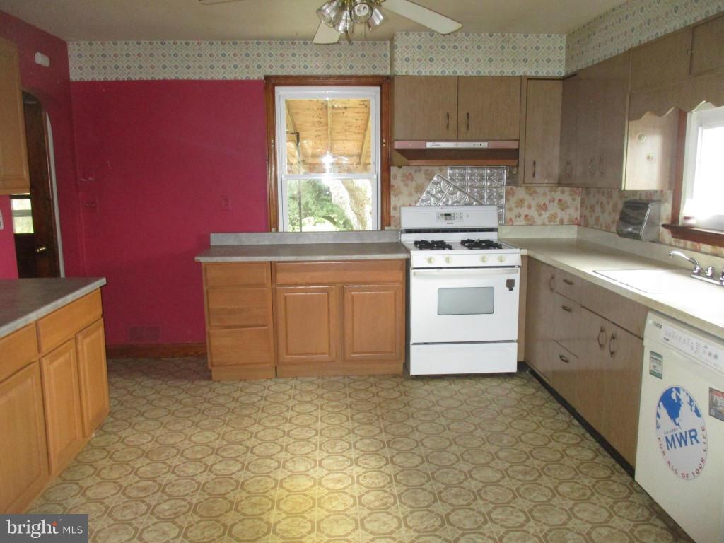 5716 Hilltop Road Baltimore, MD 21220 - Photo 8 of 12 a kitchen with stainless steel appliances granite countertop a stove a sink and a microwave