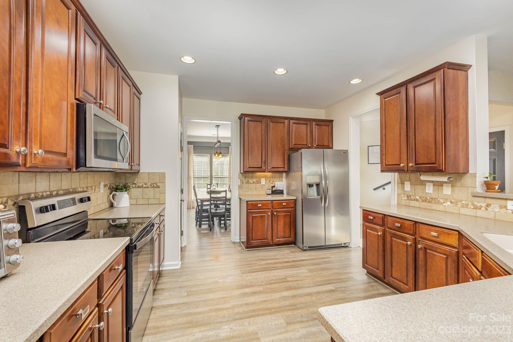2379 Smith Cove Road Denver, NC 28037 - Photo 12 of 40 a kitchen with stainless steel appliances granite countertop a refrigerator stove and sink