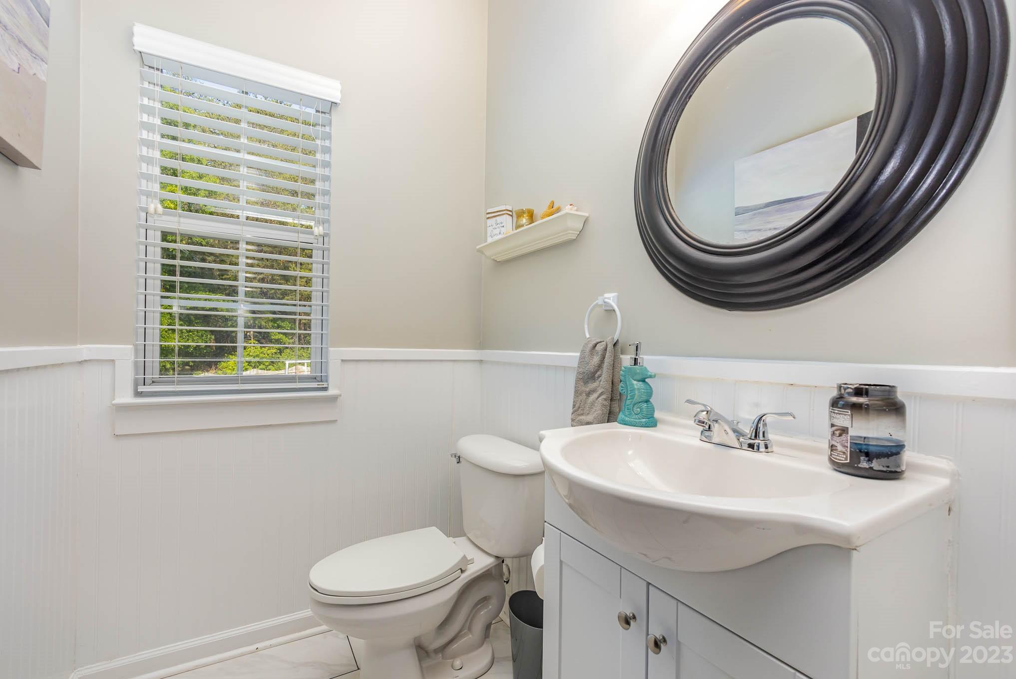 2379 Smith Cove Road Denver, NC 28037 - Photo 16 of 40 a bathroom with a sink a toilet and a mirror
