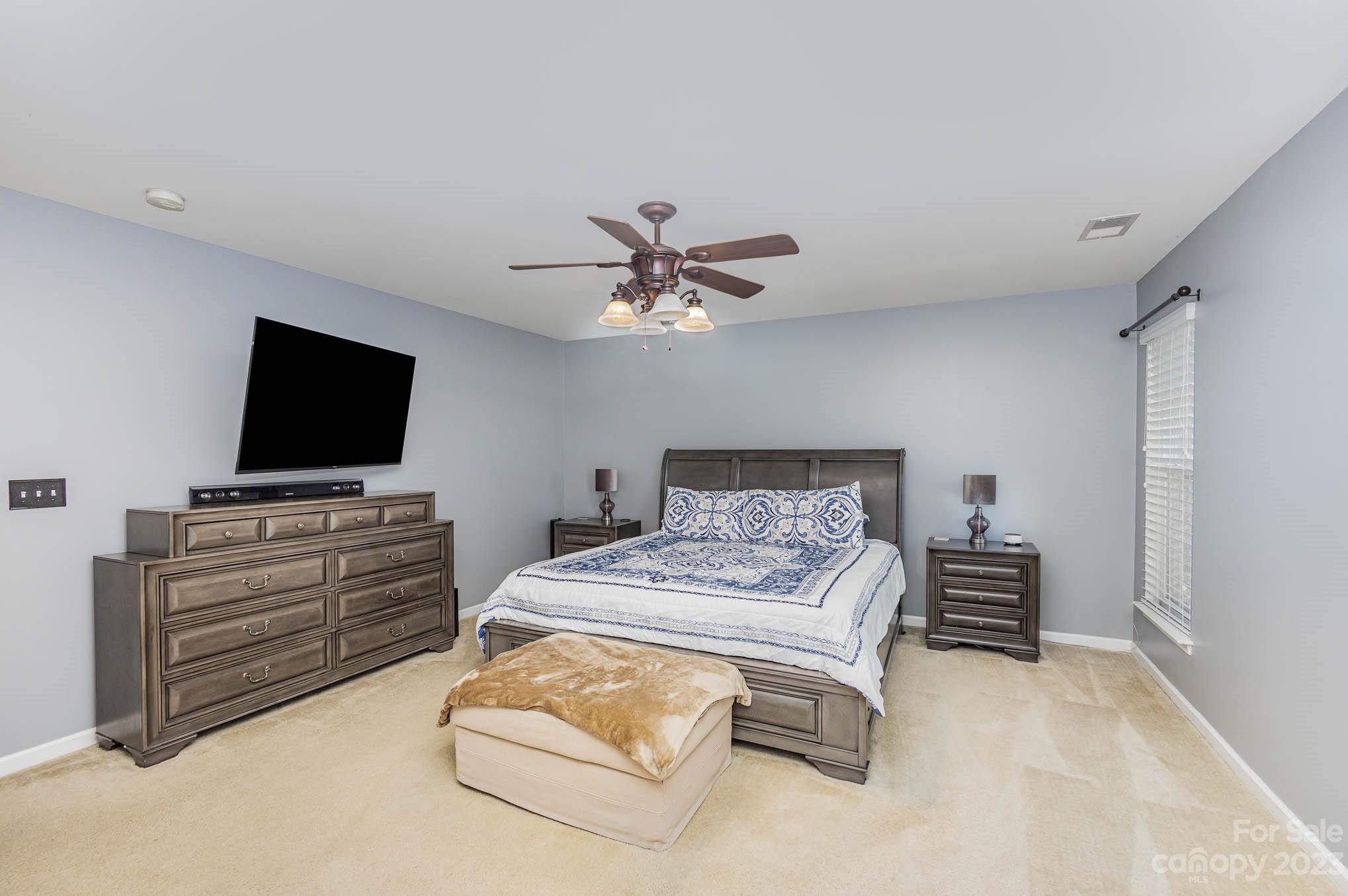 2379 Smith Cove Road Denver, NC 28037 - Photo 20 of 40 a bedroom with furniture and flat screen tv