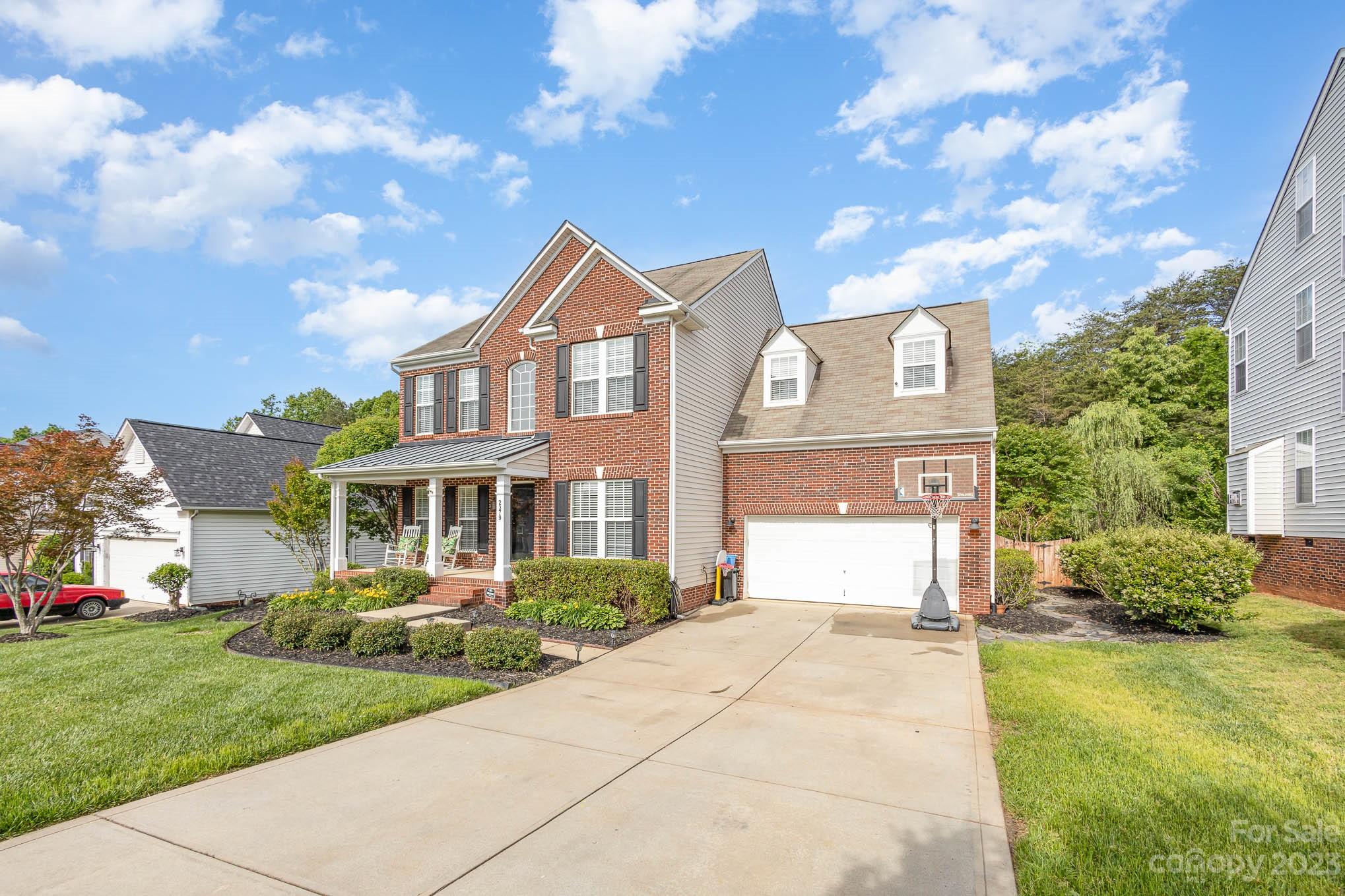 2379 Smith Cove Road Denver, NC 28037 - Photo 2 of 40 a front view of a house with a yard and trees