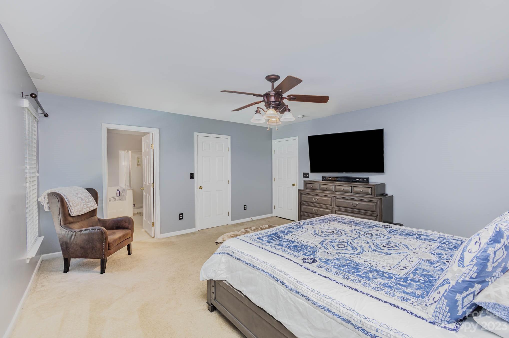 2379 Smith Cove Road Denver, NC 28037 - Photo 23 of 40 a bedroom with a bed and a flat screen tv