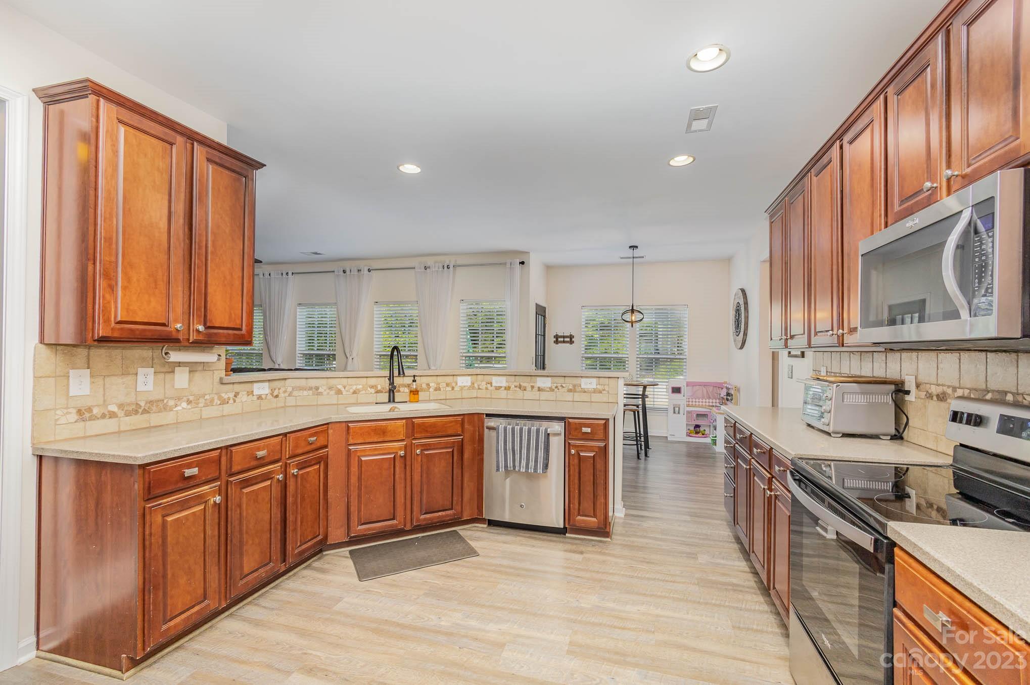 2379 Smith Cove Road Denver, NC 28037 - Photo 10 of 40 a large kitchen with stainless steel appliances granite countertop a sink stove and cabinets