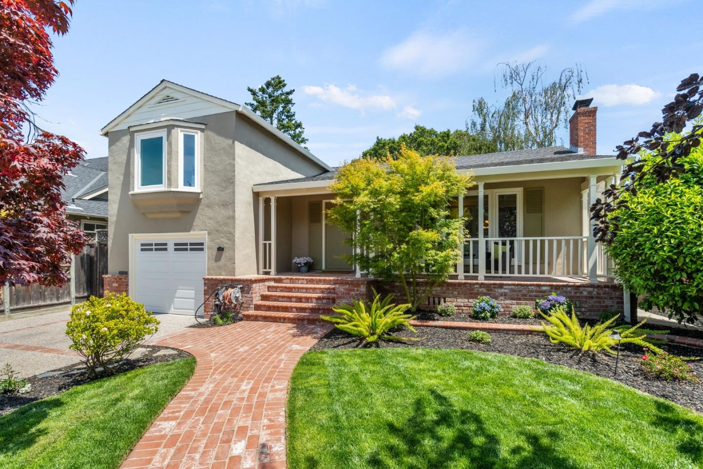 a front view of a house with garden
