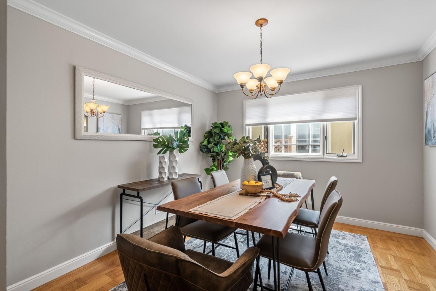 1127 Eastmoor Road Burlingame, CA 94010 - Photo 11 of 58 a dining room with furniture a chandelier and wooden floor