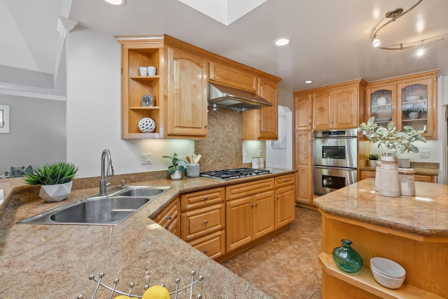 1127 Eastmoor Road Burlingame, CA 94010 - Photo 15 of 58 a kitchen with stainless steel appliances granite countertop a sink and a refrigerator