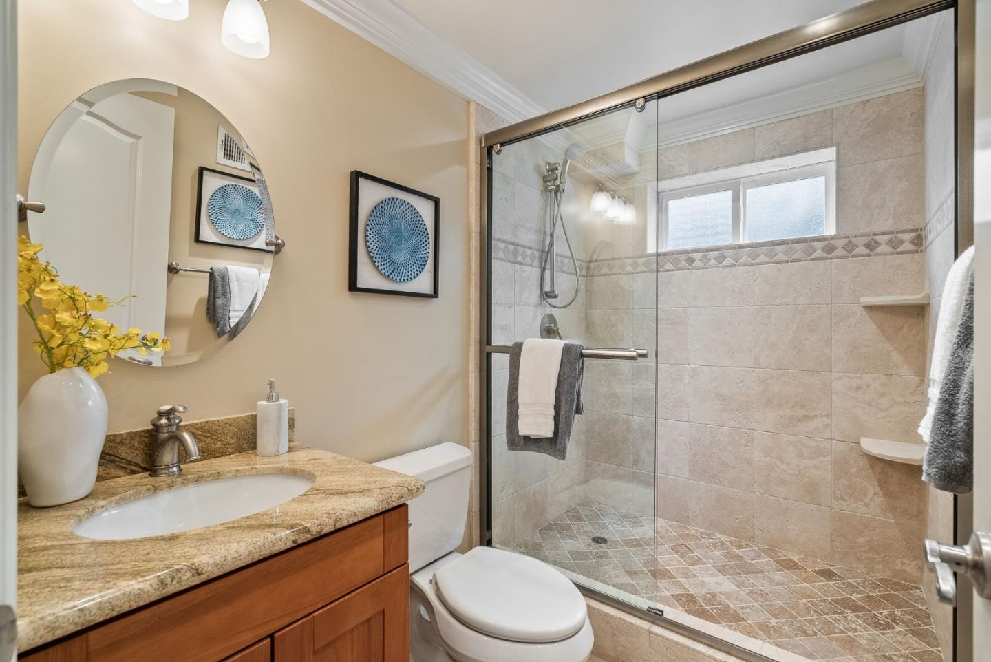 1127 Eastmoor Road Burlingame, CA 94010 - Photo 39 of 58 a bathroom with a granite countertop sink toilet and shower