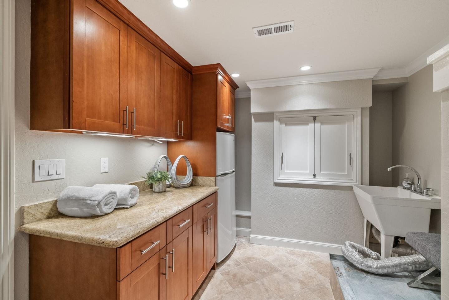 1127 Eastmoor Road Burlingame, CA 94010 - Photo 40 of 58 a kitchen with granite countertop cabinets and sink