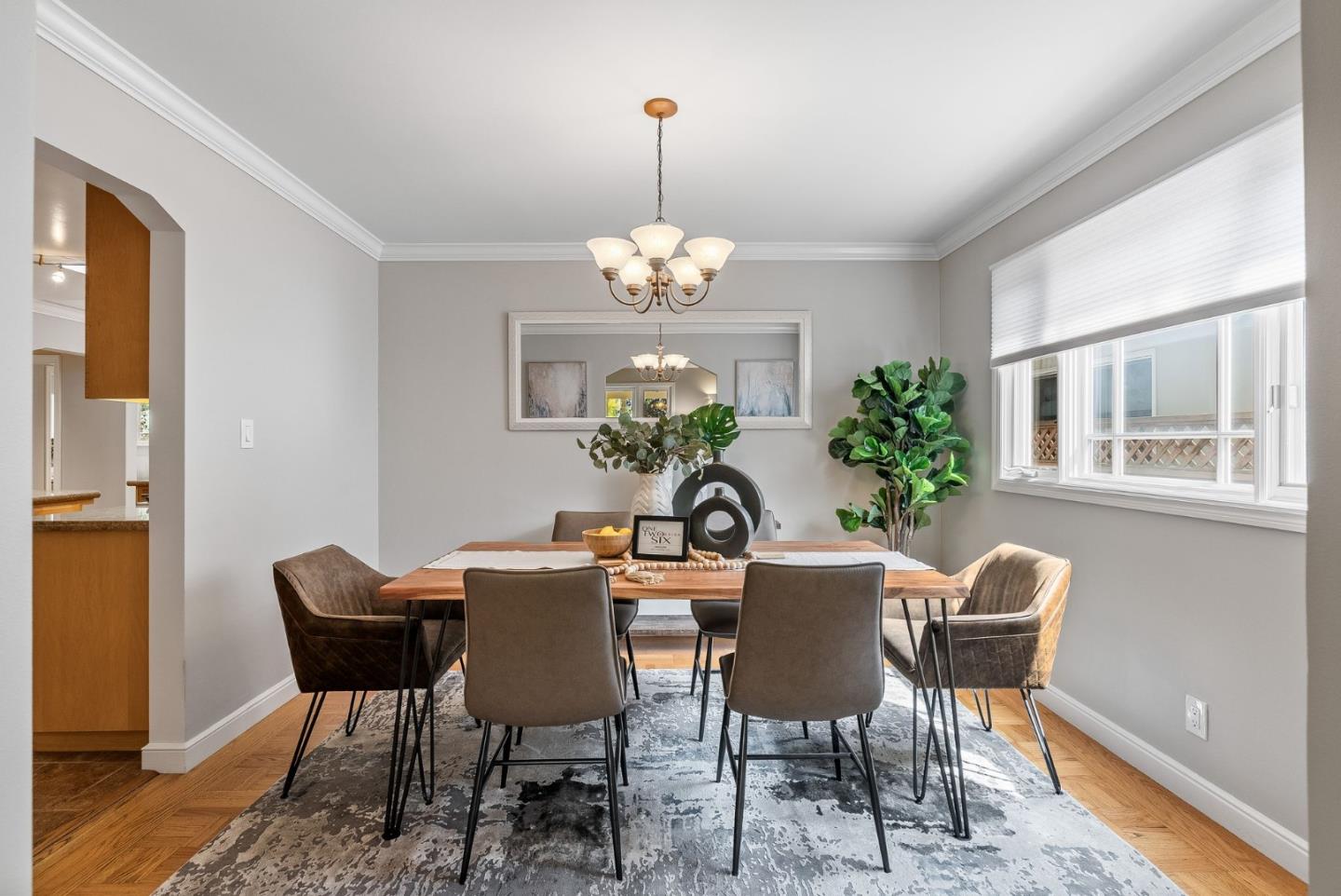 1127 Eastmoor Road Burlingame, CA 94010 - Photo 10 of 58 a view of a dining room with furniture a chandelier and wooden floor