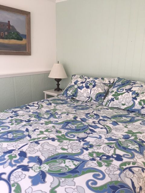 33R N Road Chilmark, MA 02535 - Photo 17 of 31 a bedroom with a bed and a painting on the wall