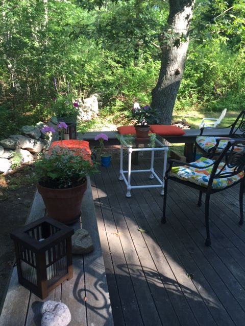 33R N Road Chilmark, MA 02535 - Photo 20 of 31 a view of an chairs and table in the patio