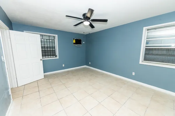 a view of a livingroom with a ceiling fan and window