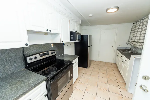 a kitchen with a stove and a refrigerator