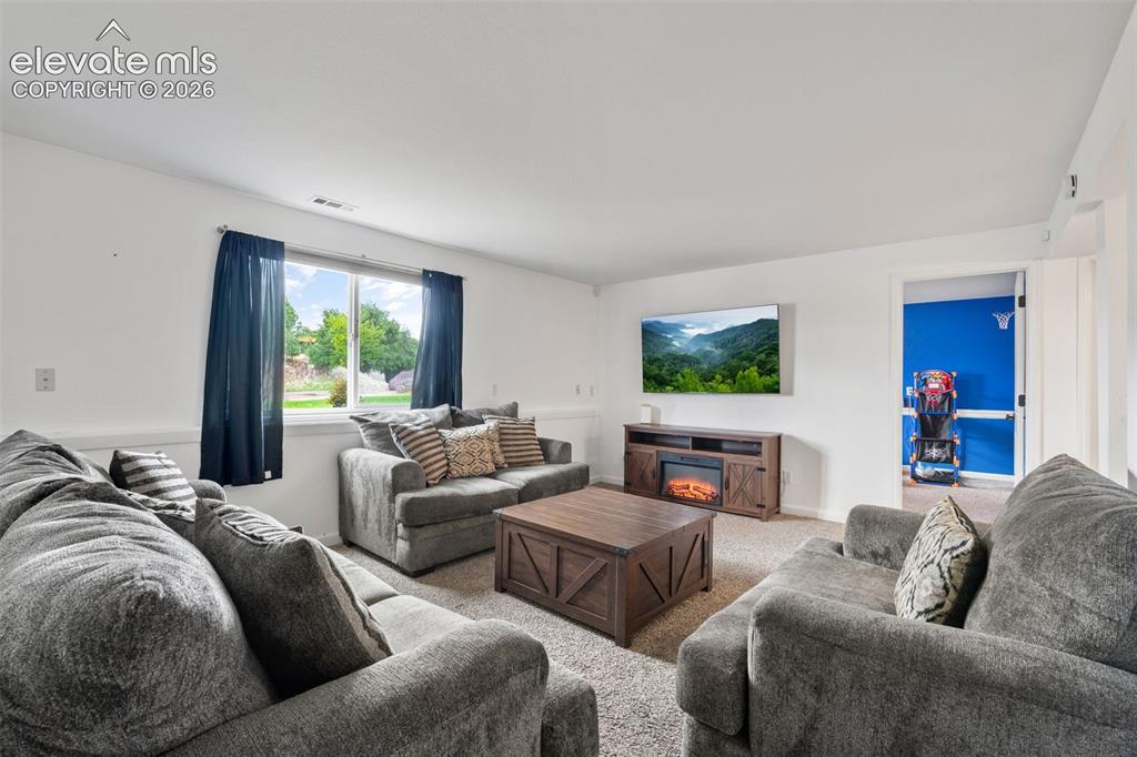 125 Diamond E Road Fountain, CO 80817 - Photo 22 of 43 a living room with furniture and a flat screen tv