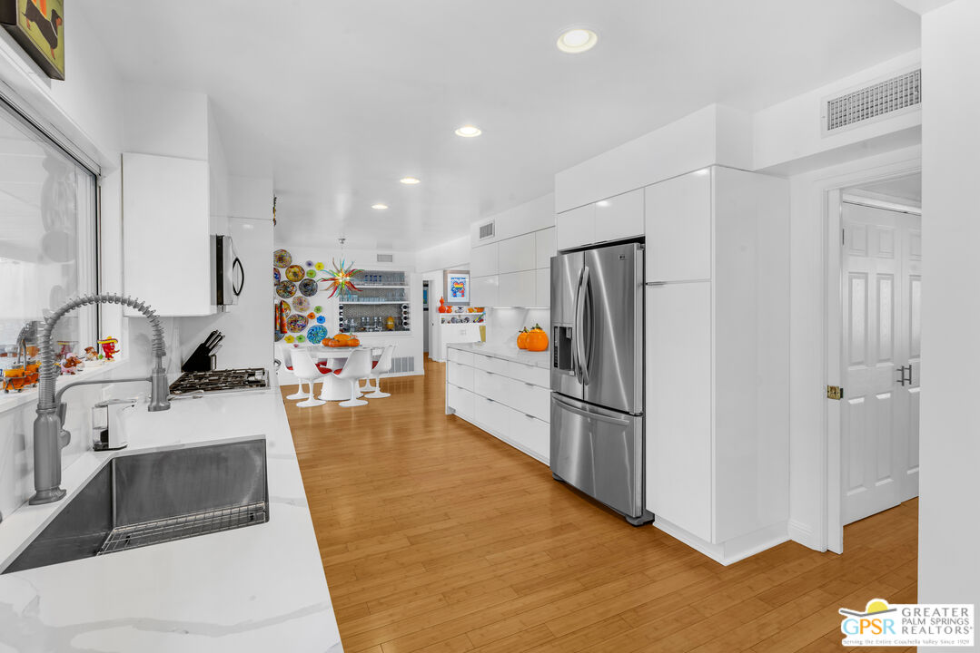 68401 Rodeo Road Cathedral City, CA 92234 - Photo 12 of 46 a kitchen with stainless steel appliances granite countertop a refrigerator and a sink
