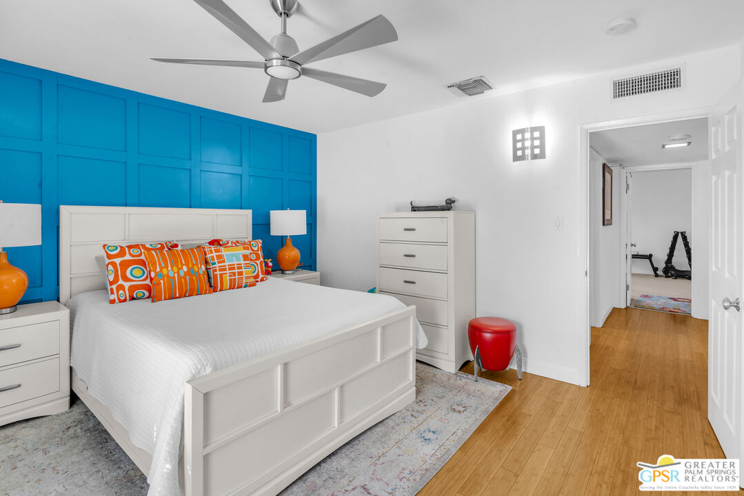 68401 Rodeo Road Cathedral City, CA 92234 - Photo 16 of 46 a bedroom with a bed and a chandelier