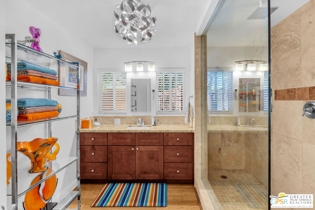 68401 Rodeo Road Cathedral City, CA 92234 - Photo 18 of 46 a bathroom with a sink a vanity and a shower