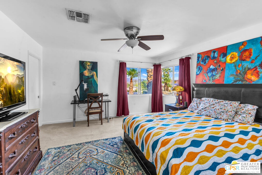 68401 Rodeo Road Cathedral City, CA 92234 - Photo 23 of 46 a bedroom with a bed and a flat screen tv