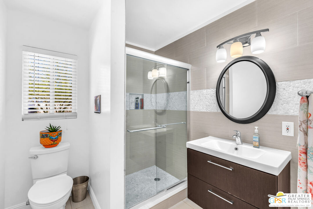 68401 Rodeo Road Cathedral City, CA 92234 - Photo 24 of 46 a bathroom with a sink a toilet and a mirror