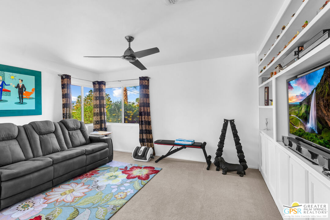 68401 Rodeo Road Cathedral City, CA 92234 - Photo 26 of 46 a living room with furniture a flat screen tv and a window