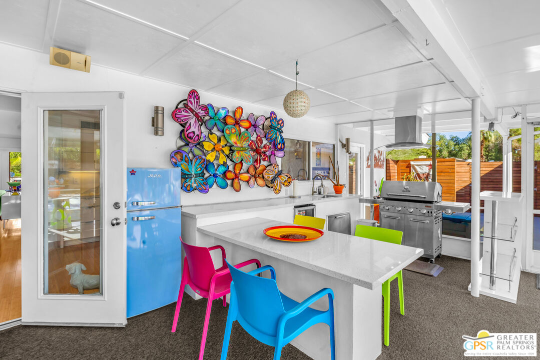 68401 Rodeo Road Cathedral City, CA 92234 - Photo 30 of 46 a view of a dining room with furniture a kitchen view and a chandelier