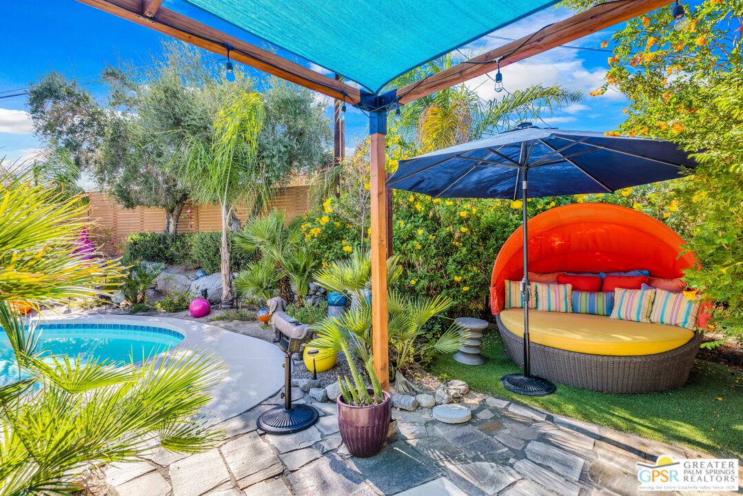 68401 Rodeo Road Cathedral City, CA 92234 - Photo 39 of 46 a view of a backyard with a table and chairs under an umbrella