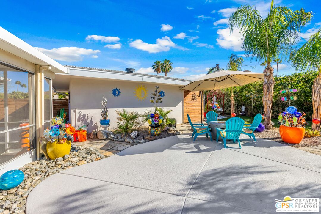 68401 Rodeo Road Cathedral City, CA 92234 - Photo 42 of 46 a view of the patio with dining table and chairs under an umbrella