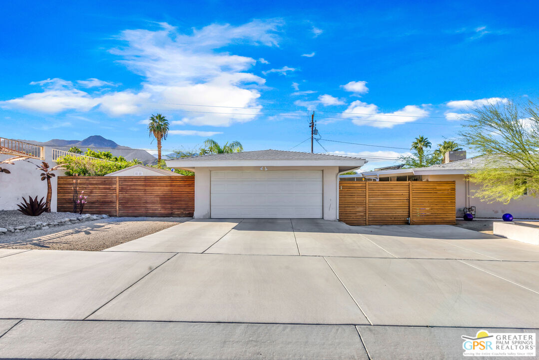 68401 Rodeo Road Cathedral City, CA 92234 - Photo 7 of 46 a front view of a house with a yard and garage