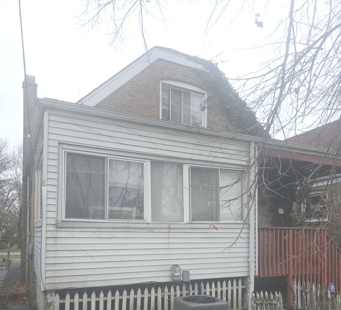8411 South Indiana Avenue Chicago, IL 60619 - Photo 4 of 7 a view of a house with a window and wooden fence