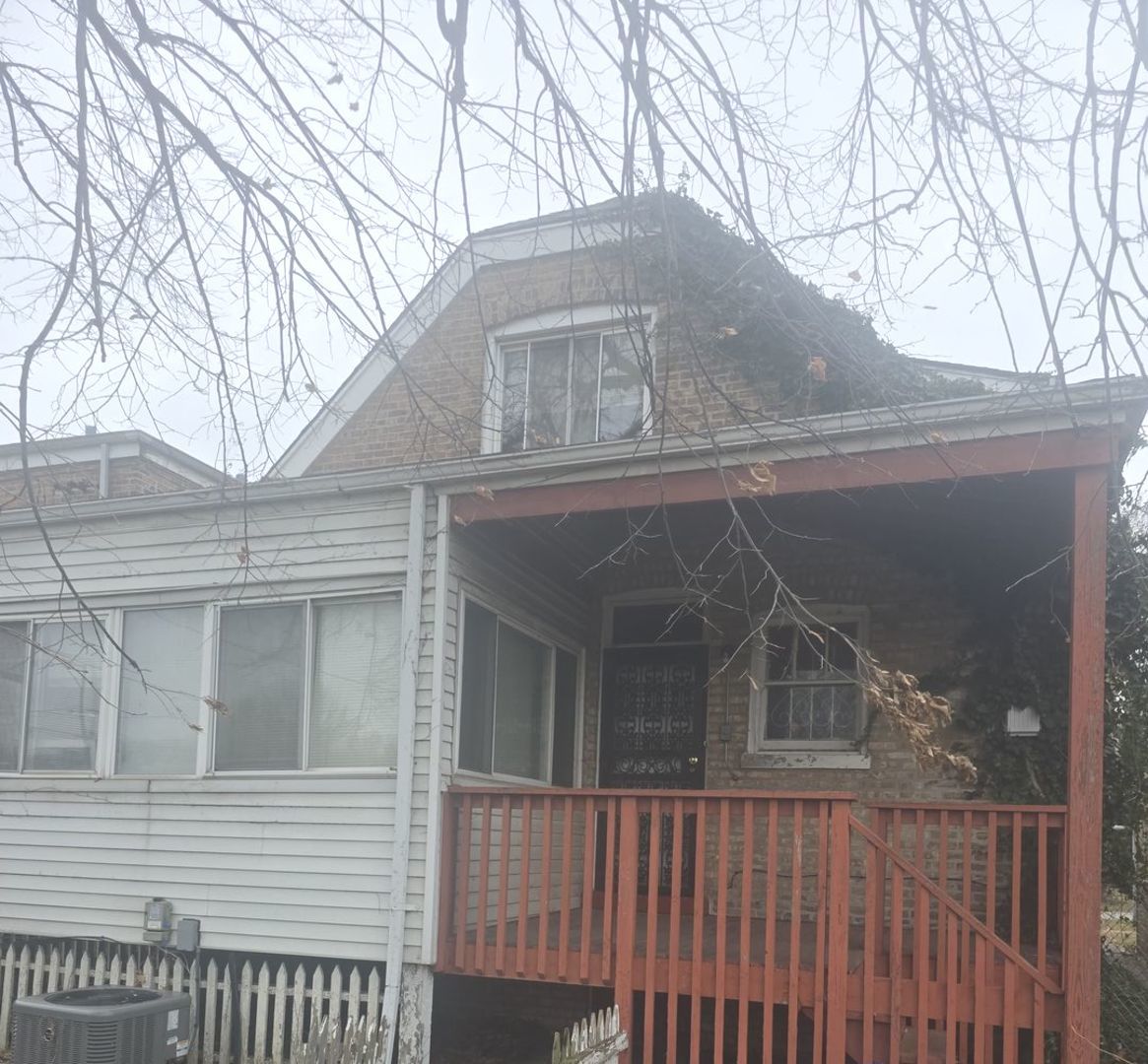 8411 South Indiana Avenue Chicago, IL 60619 - Photo 5 of 7 a view of a house with a snow on the wall