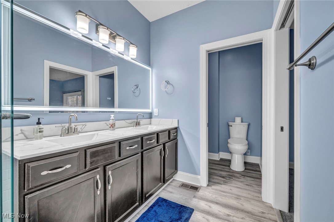 10020 Fair Road Strongsville, OH 44149 - Photo 21 of 47 Primary Bath featuring double vanity and light wood-type flooring