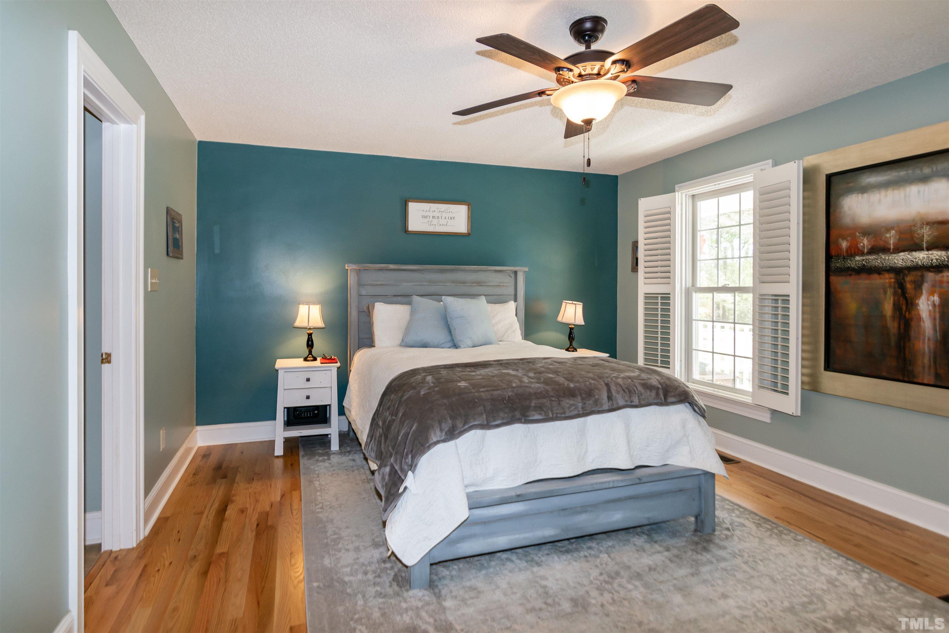 200 Lynch Road Selma, NC 27576 - Photo 35 of 79 a bedroom with a bed and a chandelier