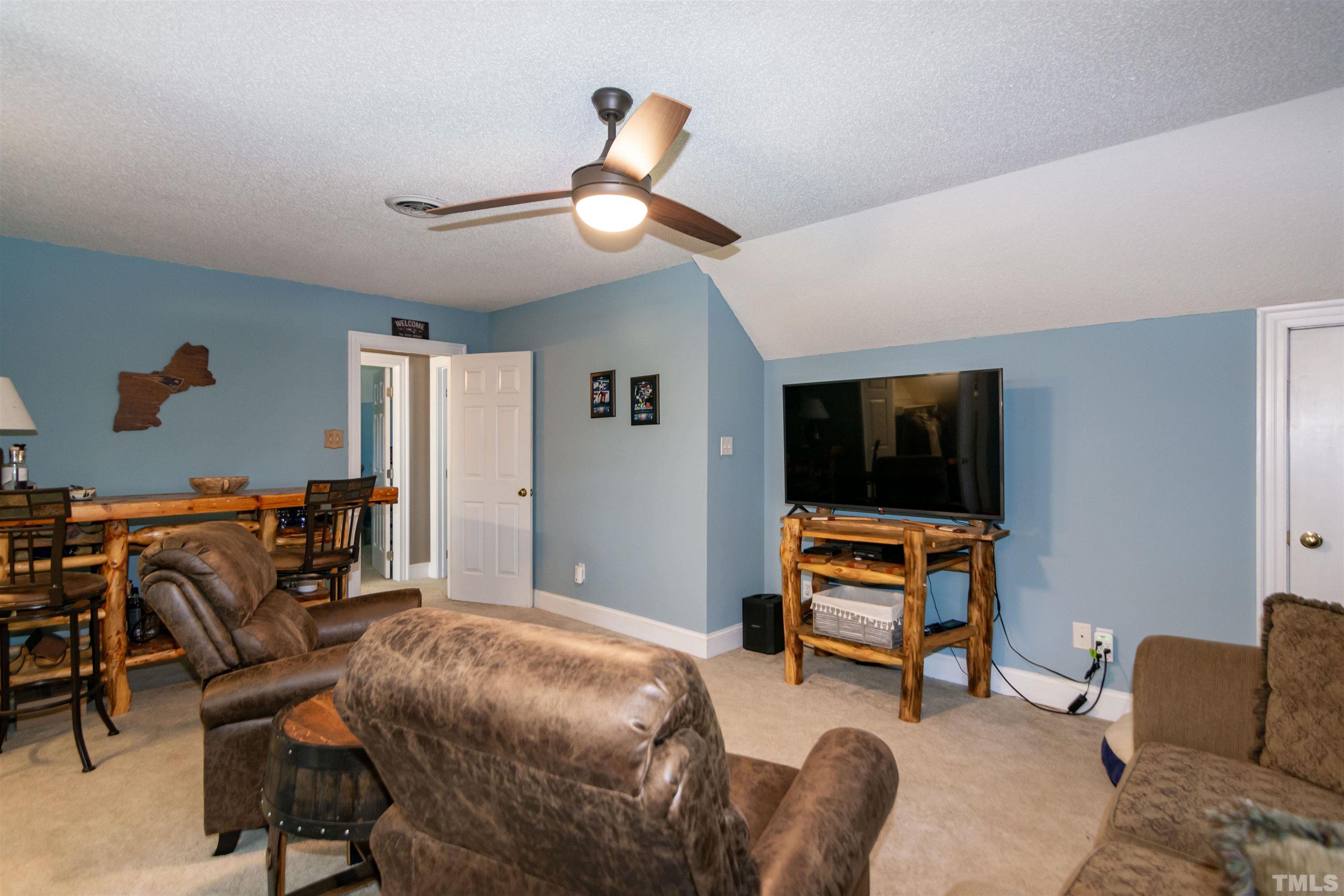 200 Lynch Road Selma, NC 27576 - Photo 54 of 79 a bedroom with furniture and a flat screen tv