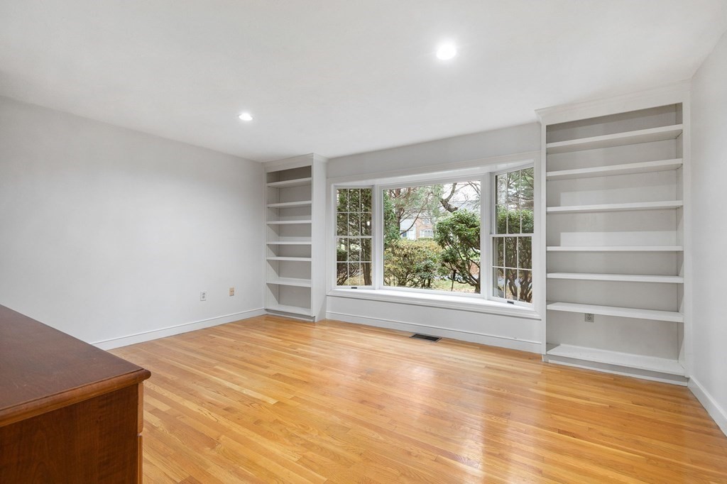 1 Sutton Place Weston, MA 02493 - Photo 11 of 33 a view of an empty room with a window and wooden floor