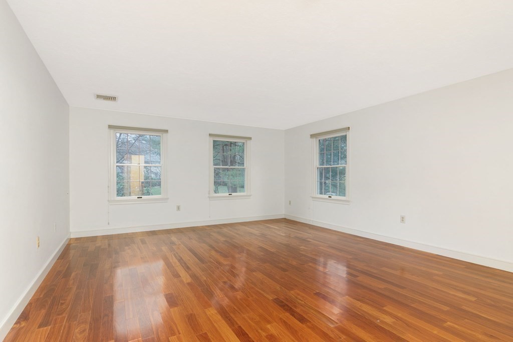 1 Sutton Place Weston, MA 02493 - Photo 15 of 33 an empty room with wooden floor and windows