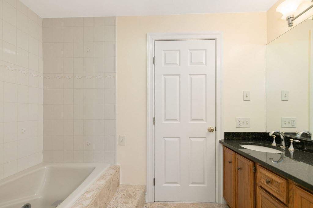 1 Sutton Place Weston, MA 02493 - Photo 18 of 33 a bathroom with a granite countertop sink and a bathtub