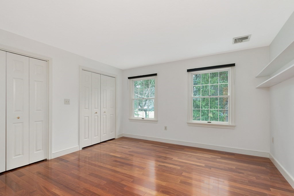 1 Sutton Place Weston, MA 02493 - Photo 19 of 33 an empty room with wooden floor and windows