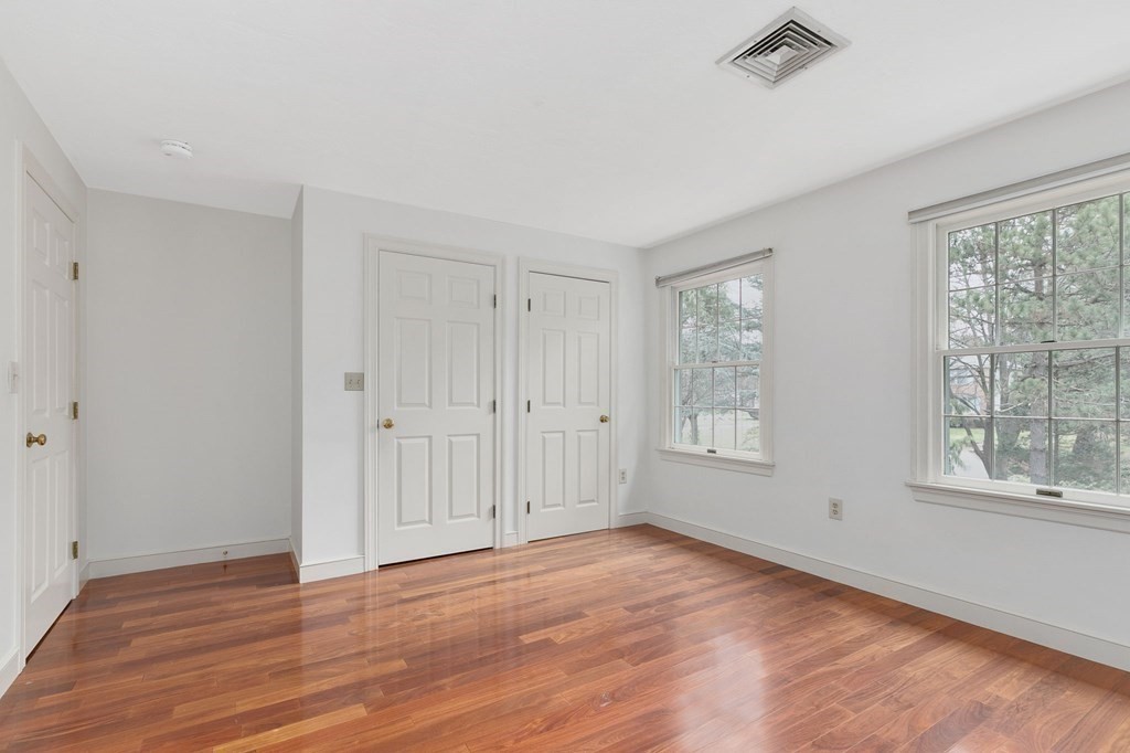 1 Sutton Place Weston, MA 02493 - Photo 20 of 33 a view of an empty room with wooden floor and a window