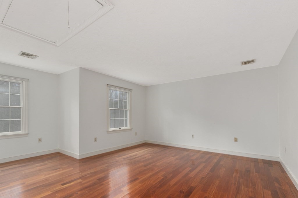 1 Sutton Place Weston, MA 02493 - Photo 21 of 33 an empty room with wooden floor and windows