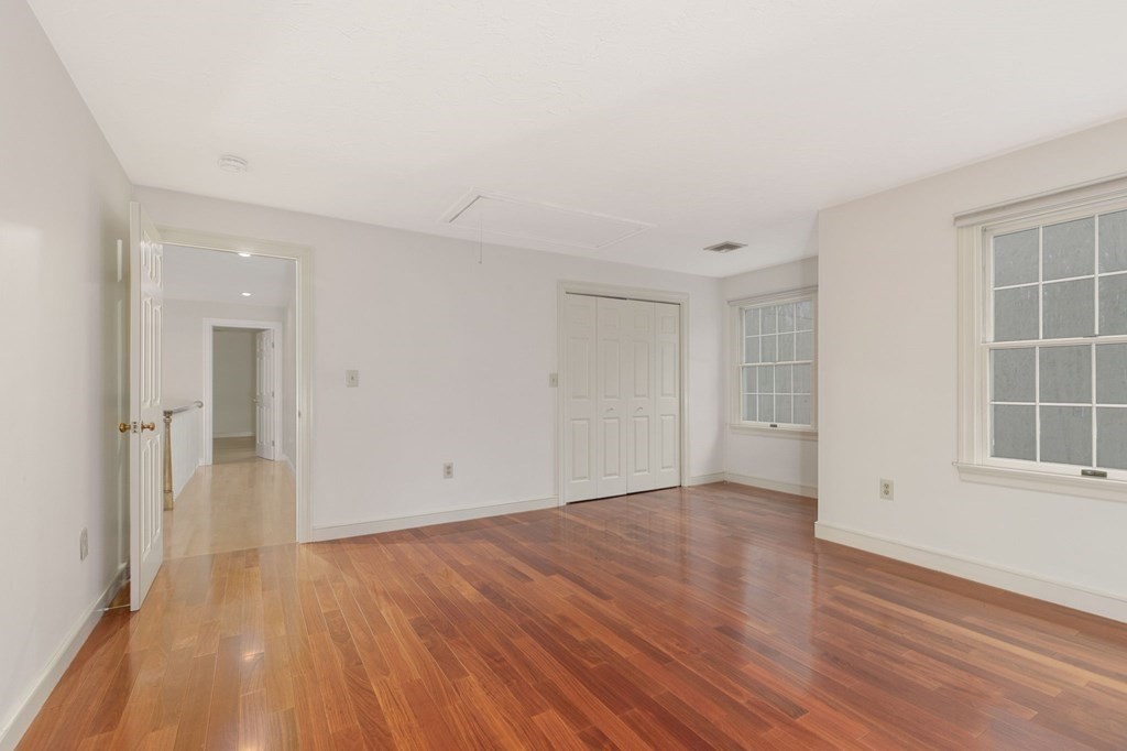 1 Sutton Place Weston, MA 02493 - Photo 22 of 33 an empty room with wooden floor and windows
