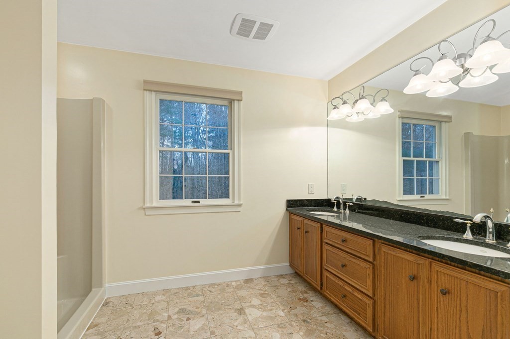 1 Sutton Place Weston, MA 02493 - Photo 23 of 33 a spacious bathroom with a granite countertop sink a mirror and a window