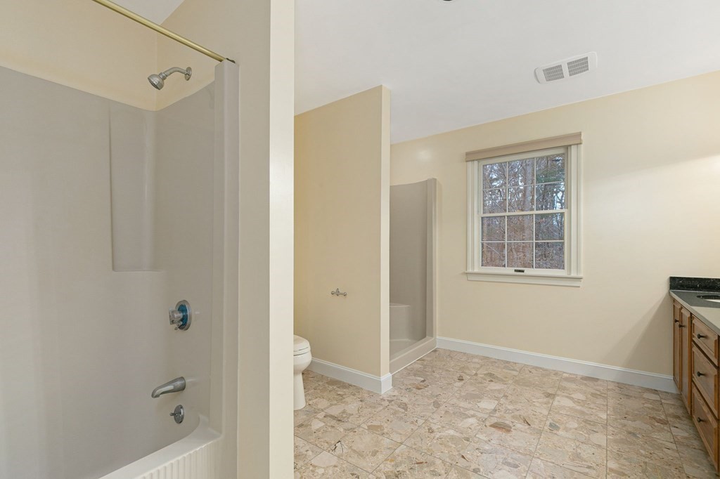 1 Sutton Place Weston, MA 02493 - Photo 24 of 33 a bathroom with a granite countertop sink a mirror and shower
