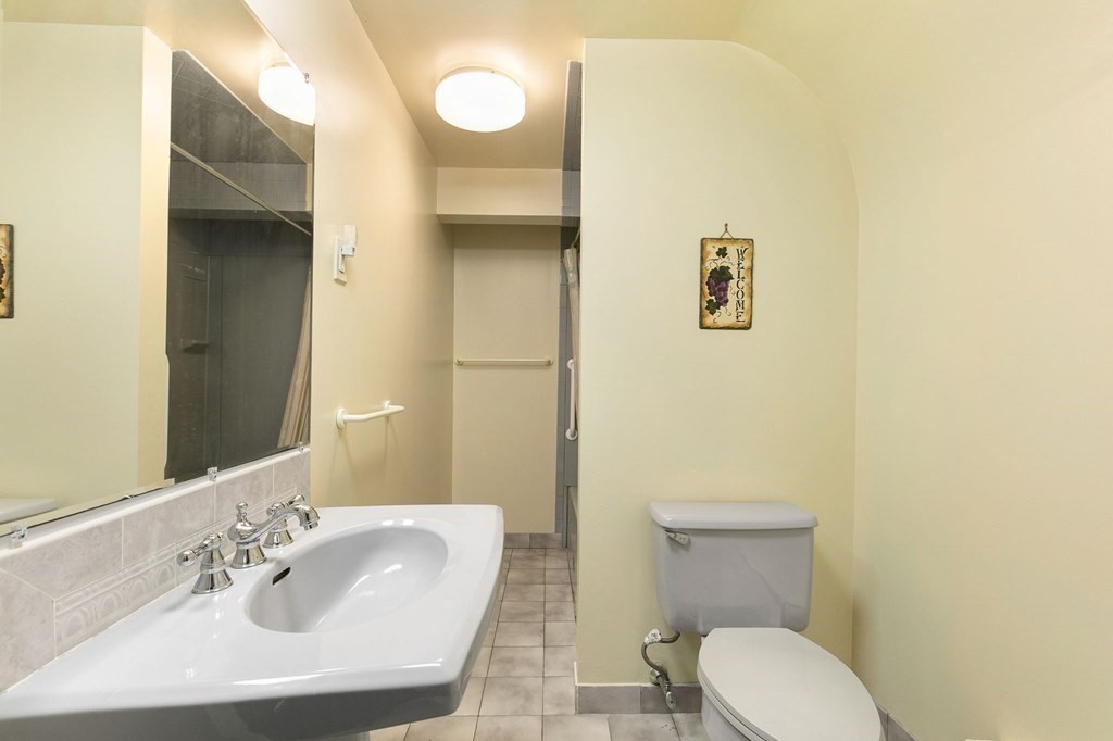 1 Sutton Place Weston, MA 02493 - Photo 28 of 33 a bathroom with a toilet sink and mirror