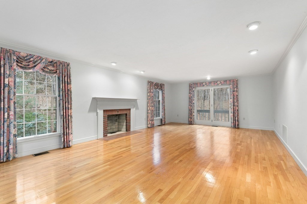 1 Sutton Place Weston, MA 02493 - Photo 3 of 33 a view of an empty room with a window and fireplace