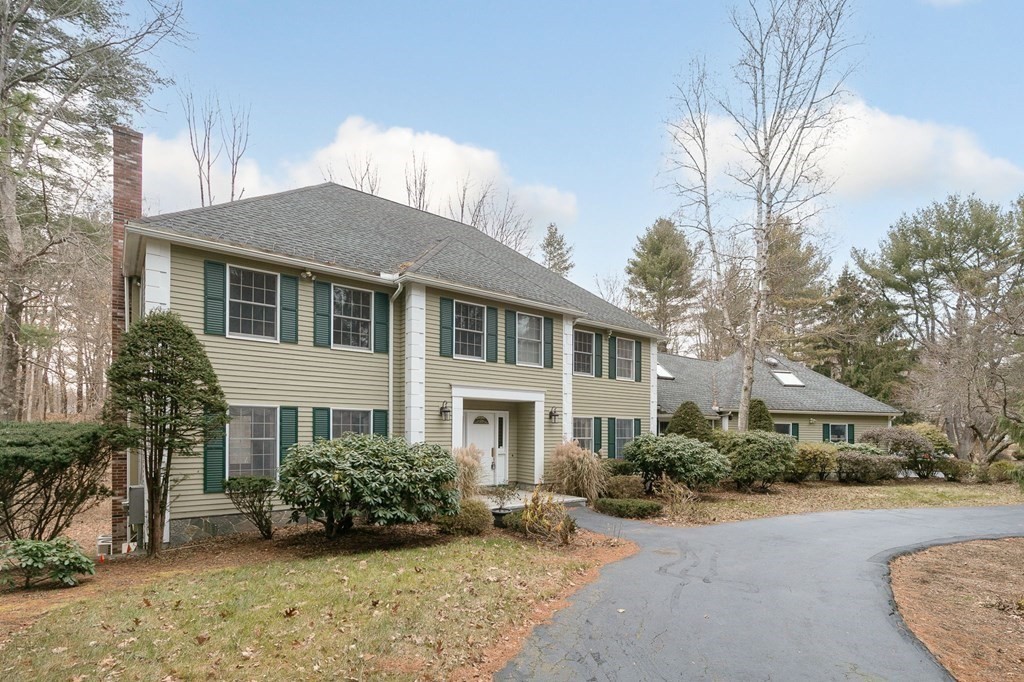 1 Sutton Place Weston, MA 02493 - Photo 31 of 33 a front view of a house with a yard and potted plants