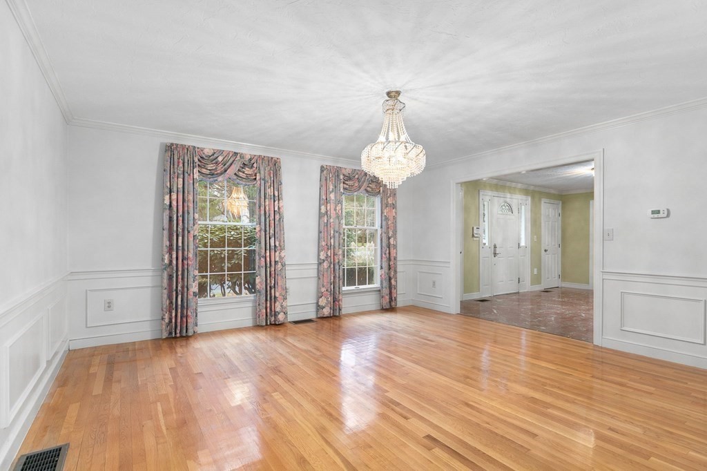 1 Sutton Place Weston, MA 02493 - Photo 8 of 33 a view of empty room with wooden floor and fan
