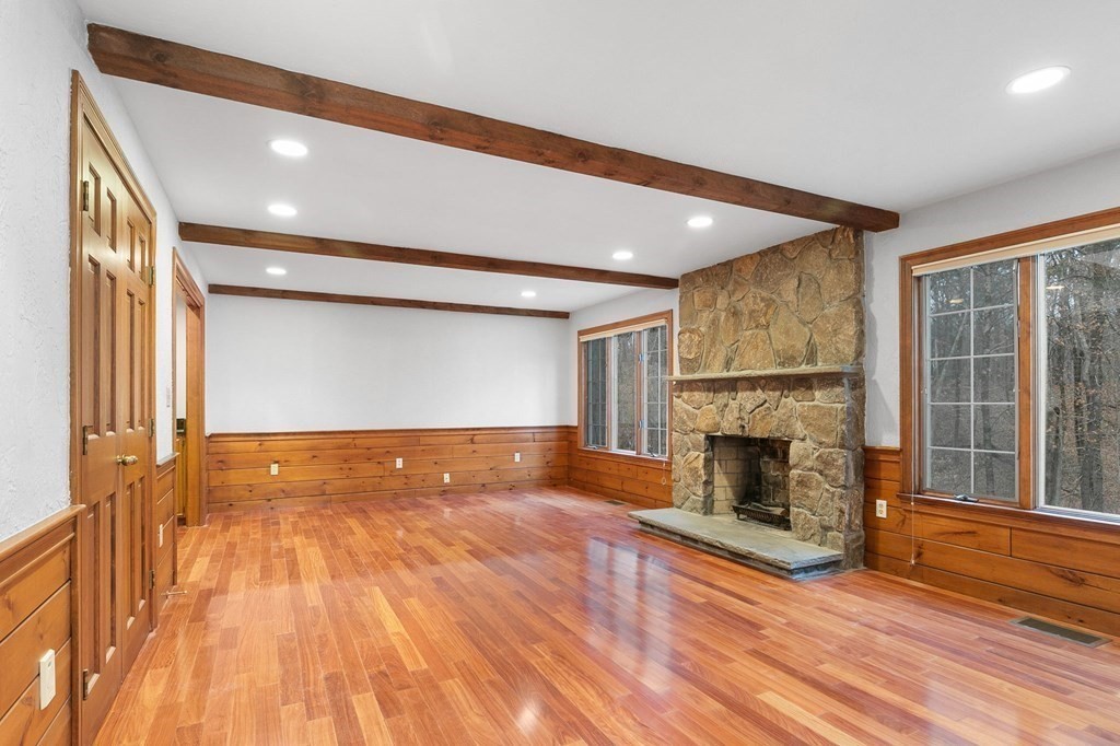 1 Sutton Place Weston, MA 02493 - Photo 9 of 33 a view of empty room with wooden floor and fireplace