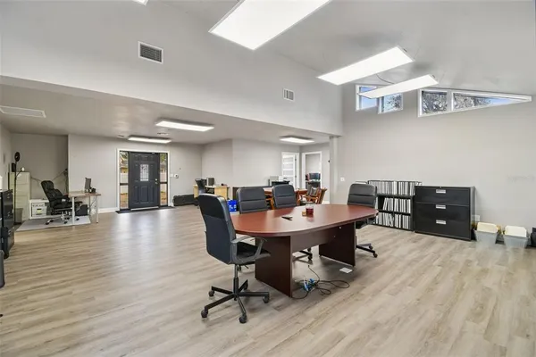 a living room with furniture a fireplace and windows