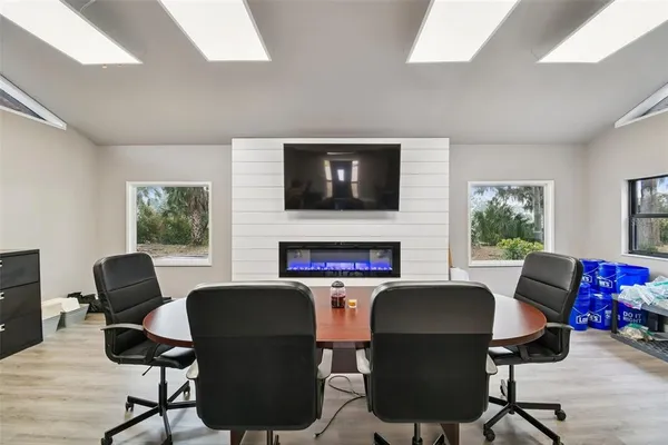 a room with lots of furniture and view of kitchen